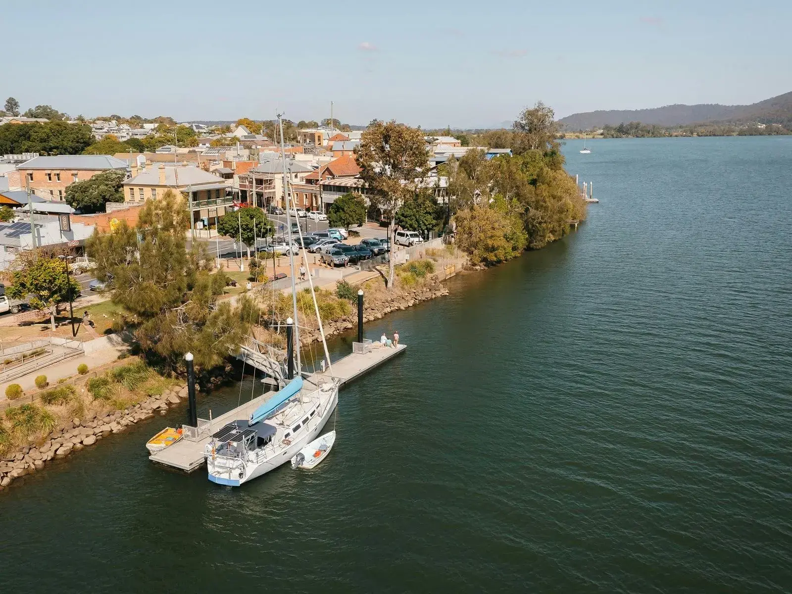 Aerial view of Maclean on a bend of the Clarence River with cane fields and hills behind
