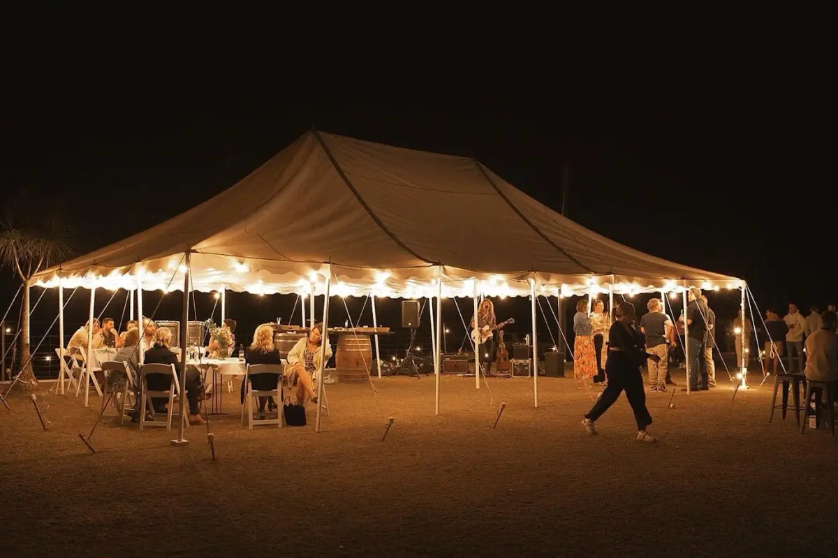 Live band playing under a festoon-lit marquee at night