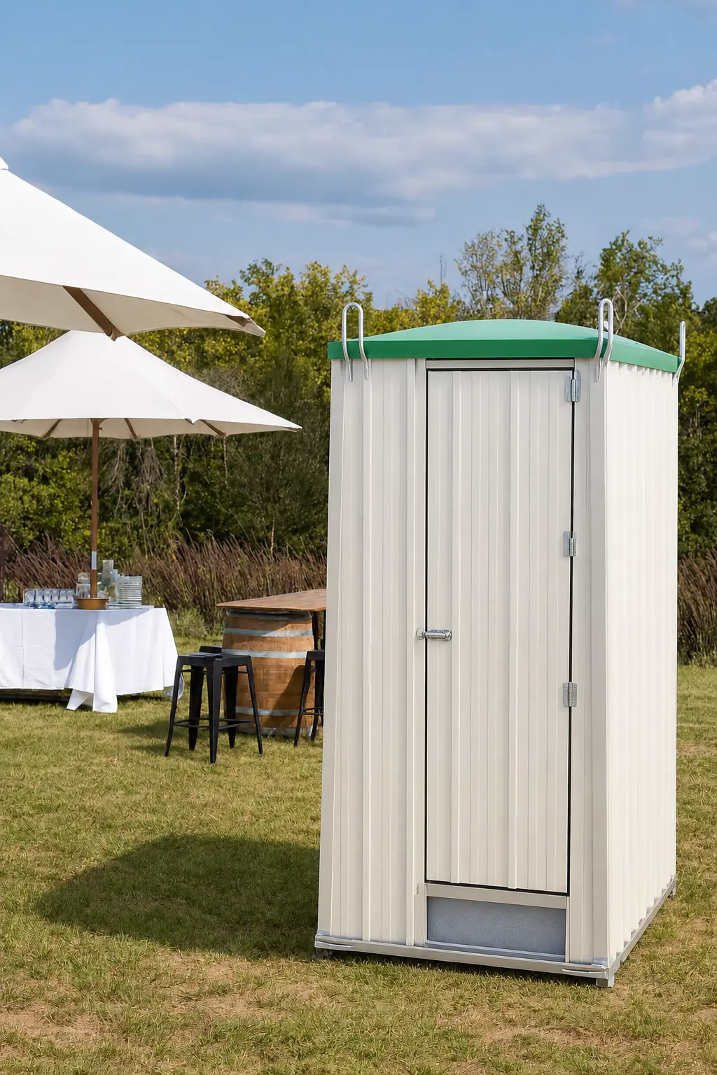 Cream corrugated portaloo with a green roof on grass, showing the model supplied by Grafton Hire