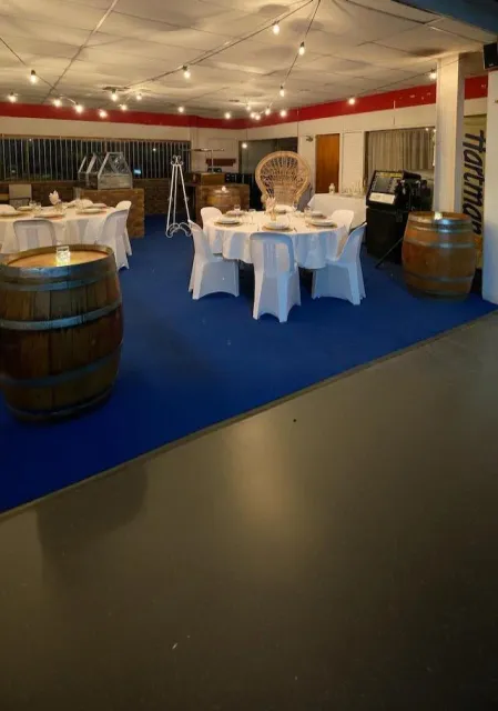 A table set with white crockery, glassware and cutlery in the Grafton Hire showroom